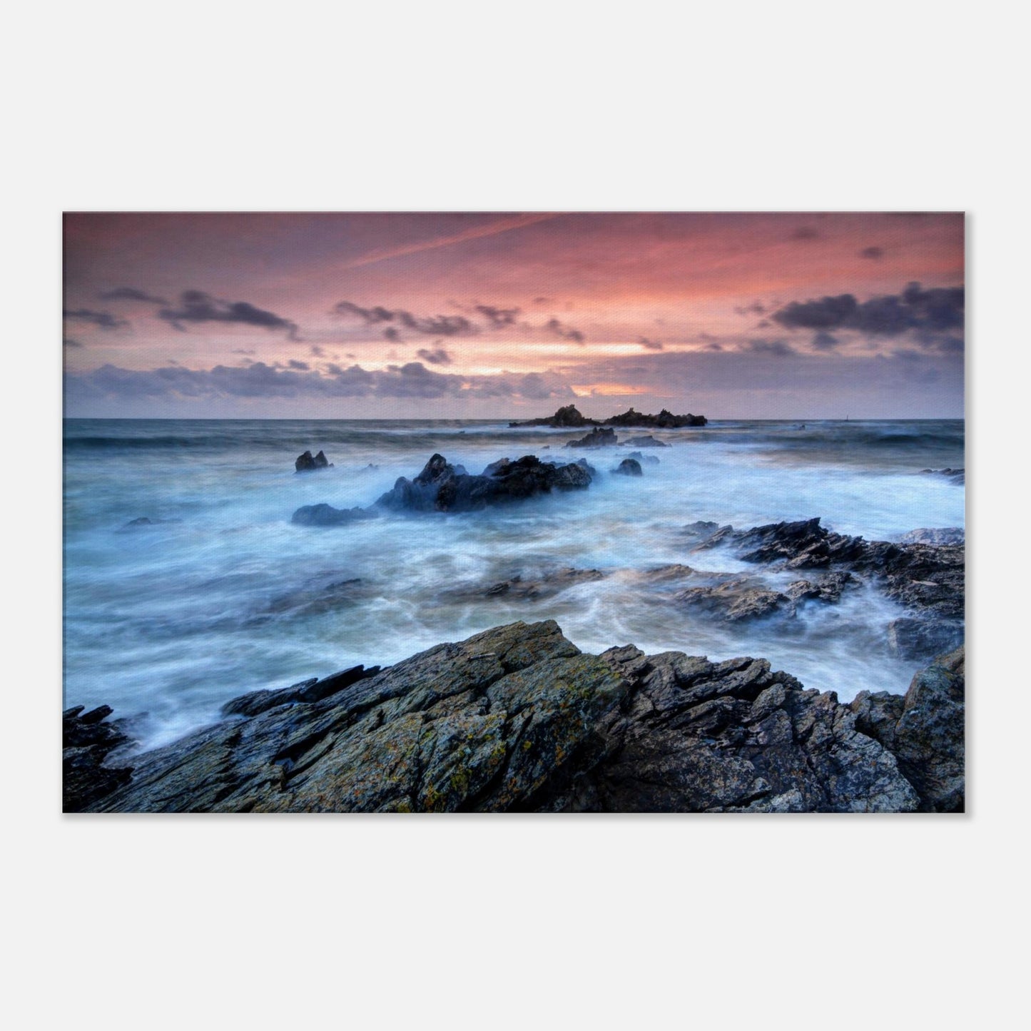 Dramatic seaside canvas of Heybrook Bay featuring frothy waves, jagged rocks, and a glowing sunset sky in reds and oranges.