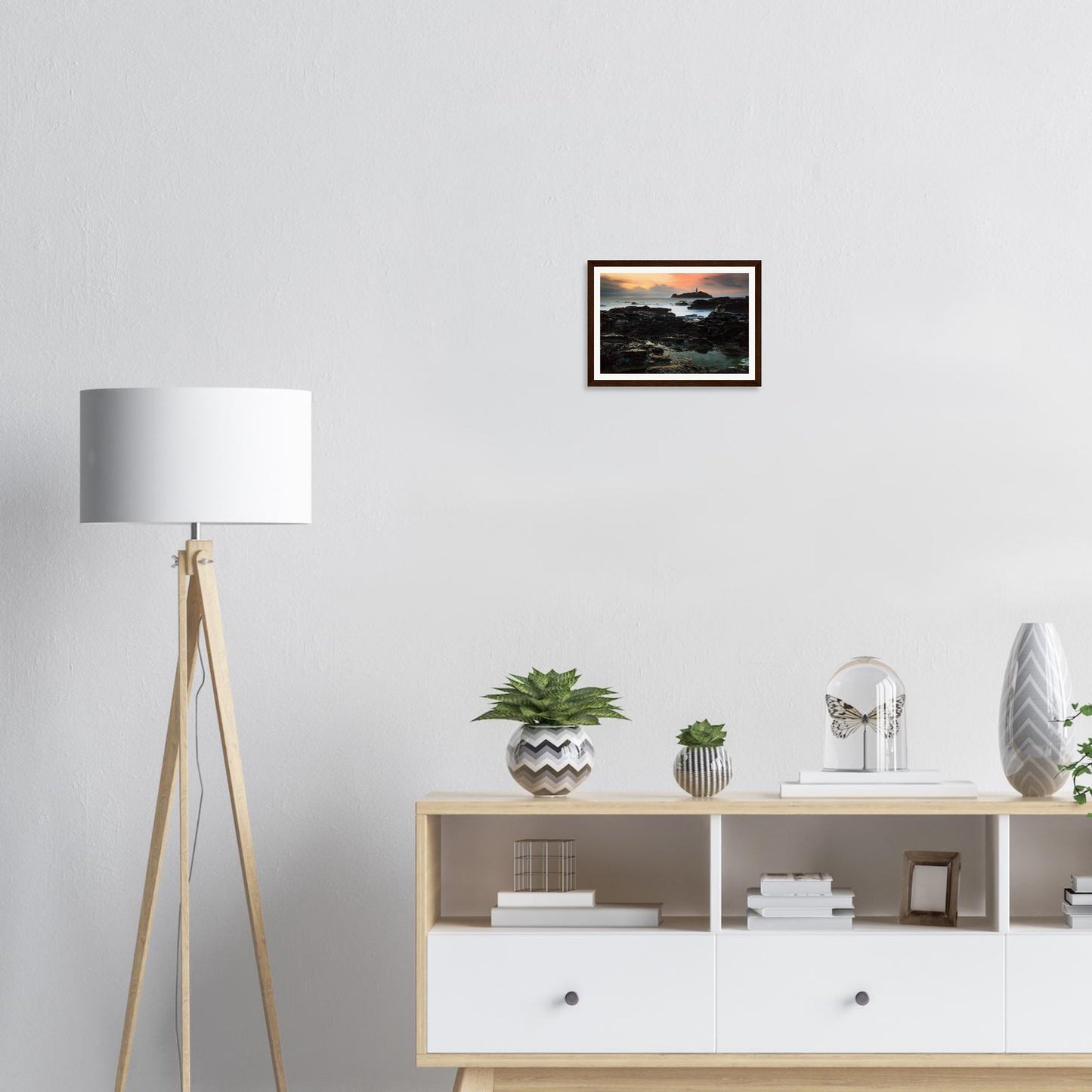 Rugged coastal rocks glowing beneath Godrevy Lighthouse framed art