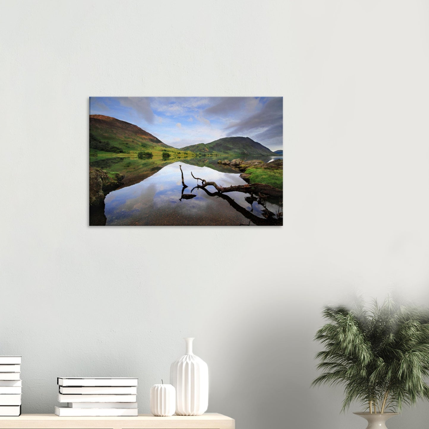 Scenic canvas print of Crummock Water showing a branch on the calm lake surface and soft reflections of hills and overcast skies.