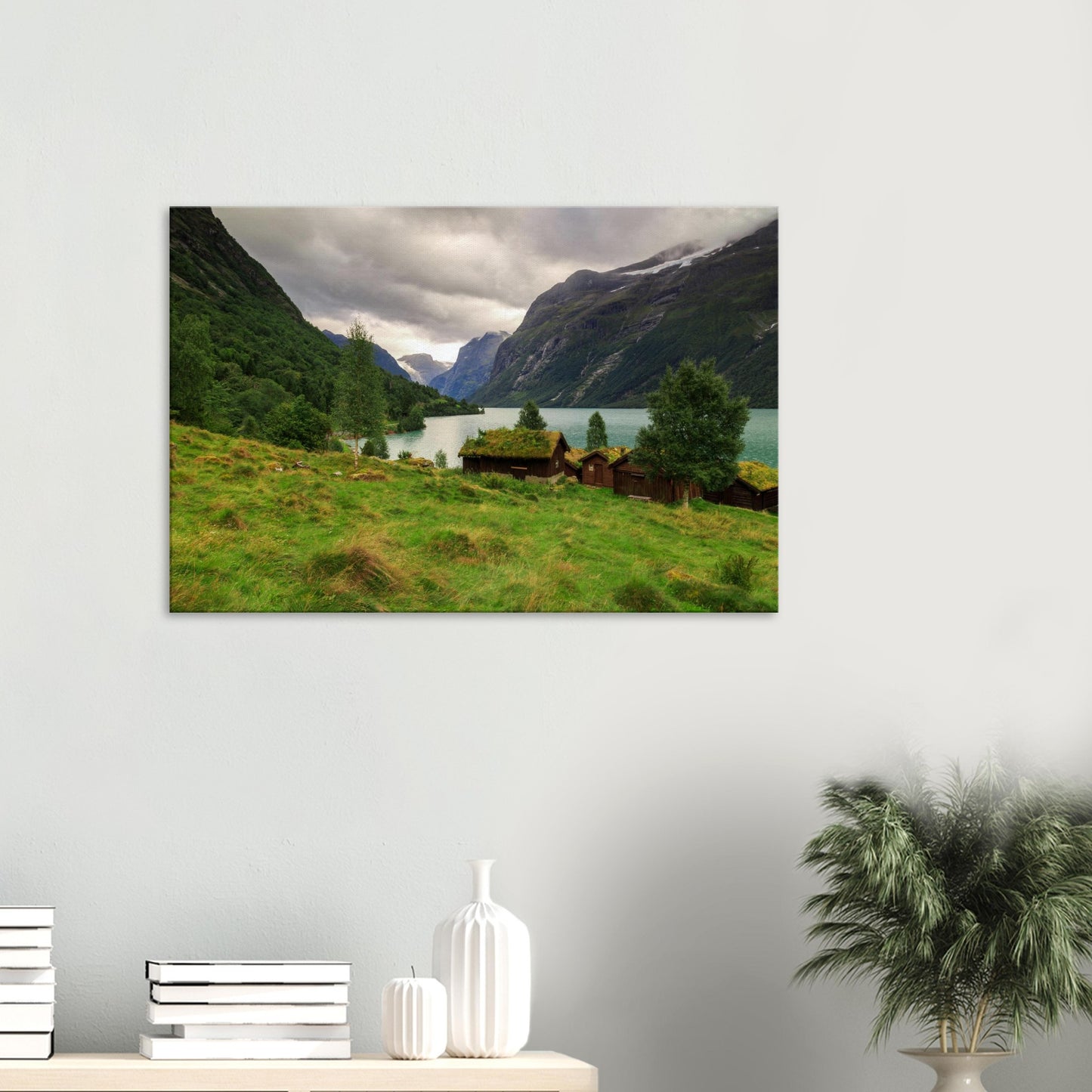 Canvas print showcasing Norway’s Lodalen Valley with traditional grass-roofed cabins by a turquoise lake and towering mountain cliffs.