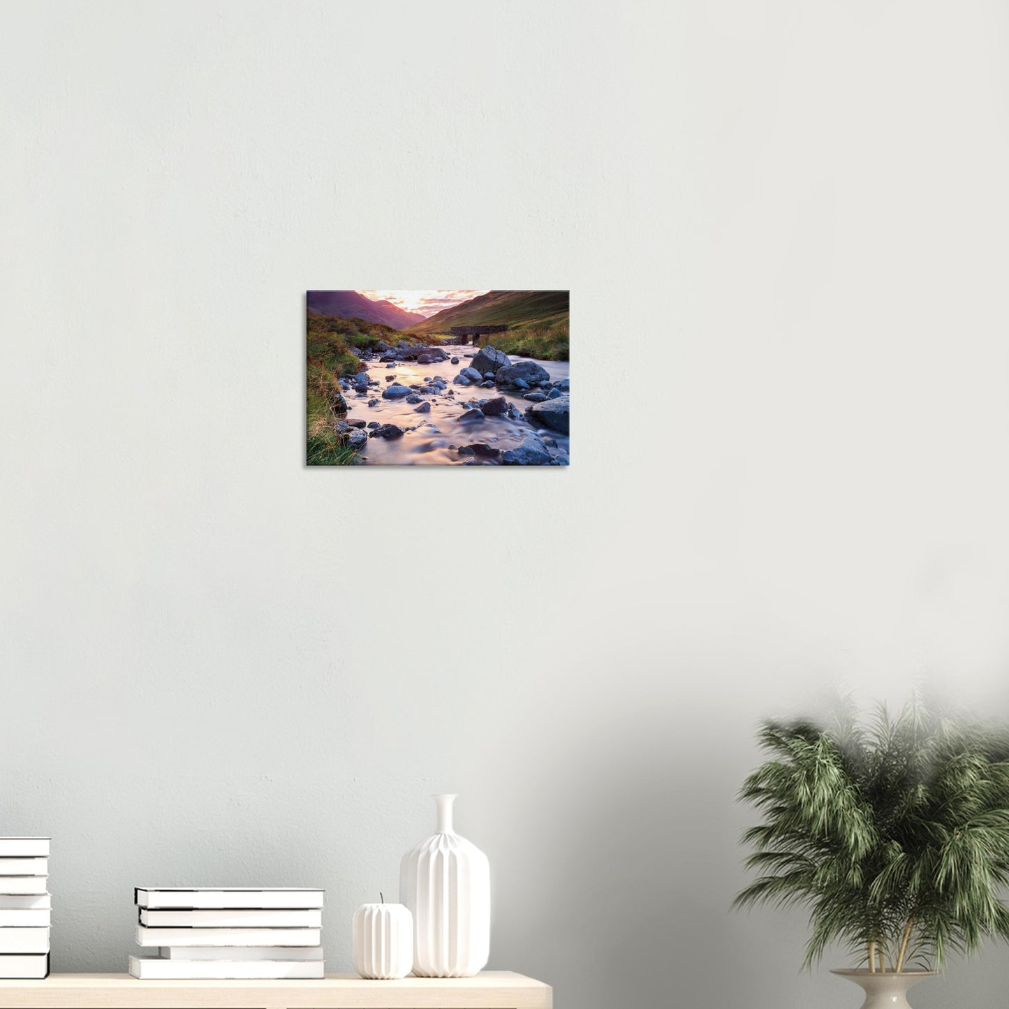 Lake District canvas print showing Honister Pass with golden hour glow, rugged landscape, and a tranquil river weaving through stones.