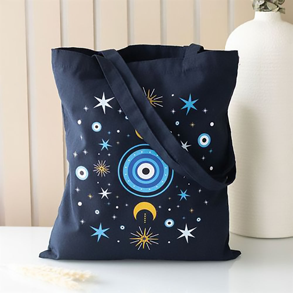 Dark blue polycotton tote bag featuring detailed all seeing eye with crescent moon and star accents.