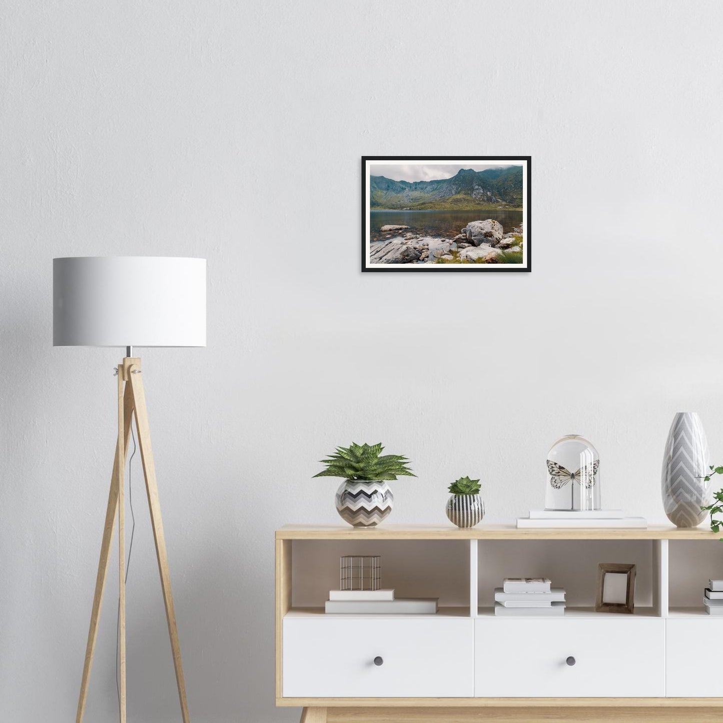 Framed wall art of Llyn Idwal with foreground rocks in lake