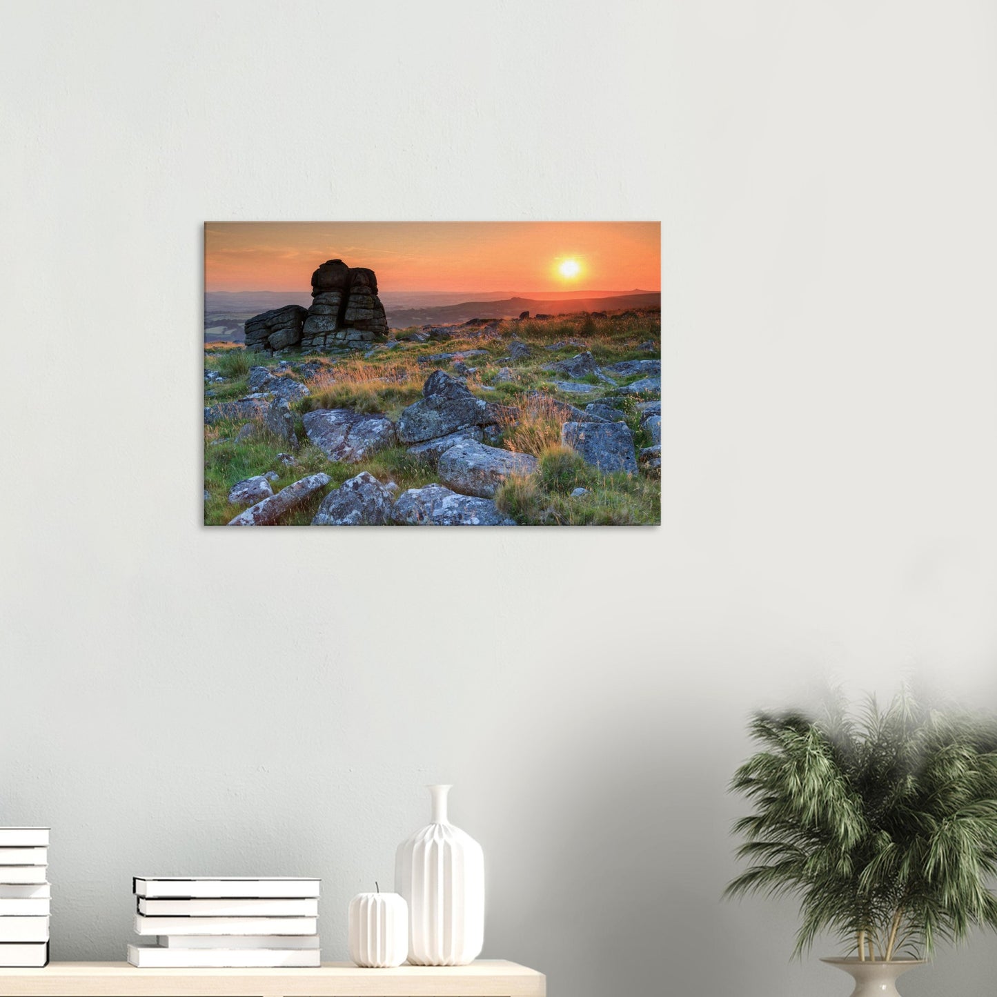 Majestic granite outcrop silhouetted against a fiery sky, embodying Dartmoor’s rugged beauty