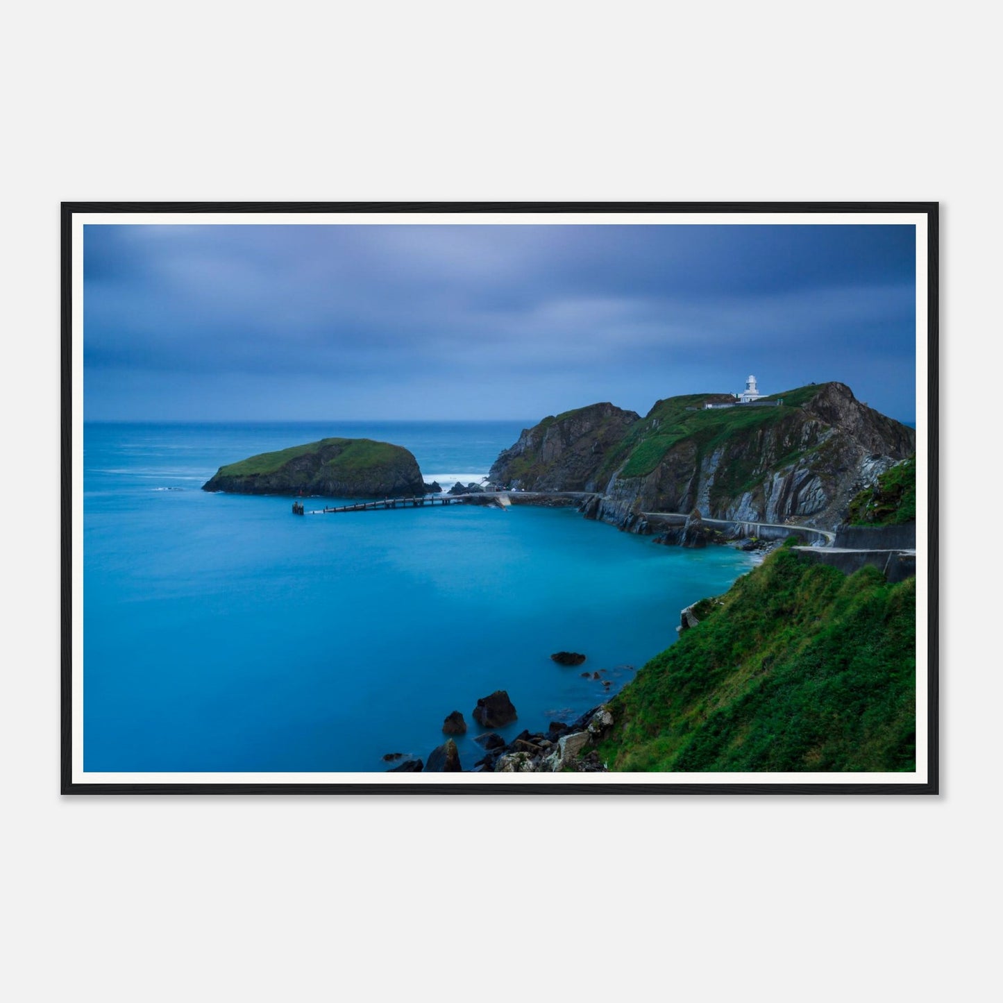 Historic lighthouse on cliffs at Landing Bay framed print