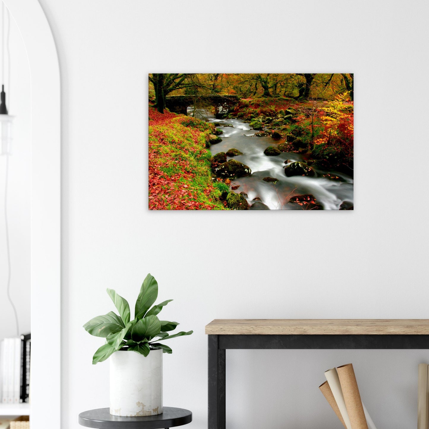 Stone bridge arch over flowing stream in autumn Dartmoor landscape