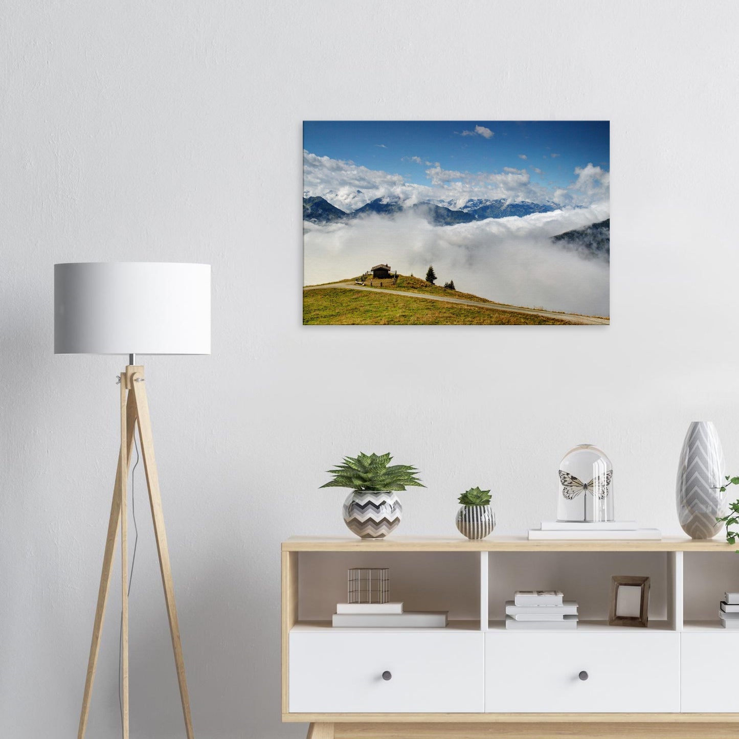 Austrian Alps canvas print with a hilltop hut at Resterhöhe, cloud-covered valley, and towering alpine summits under a vast sky.