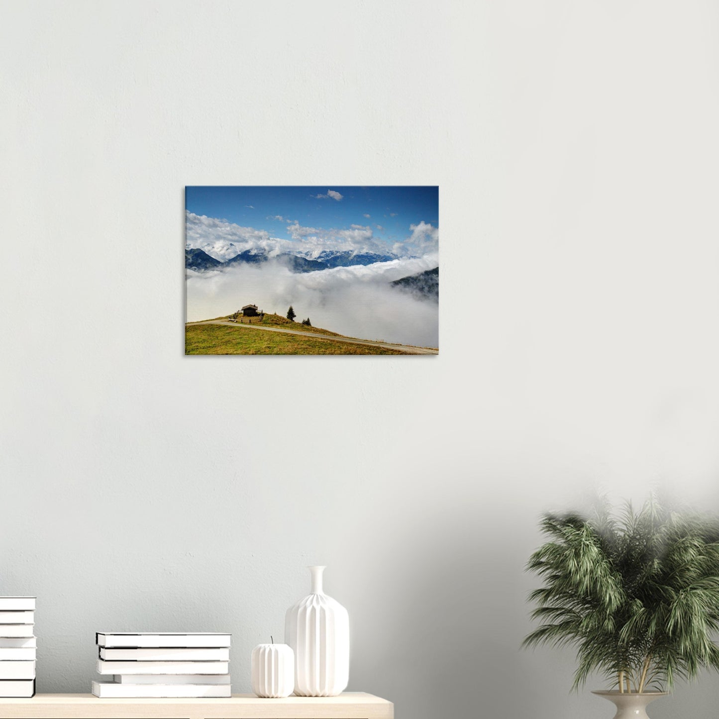 Panoramabahn canvas showing Resterhöhe’s dramatic landscape with a hut perched on a verdant hilltop and clouds covering the valley below.