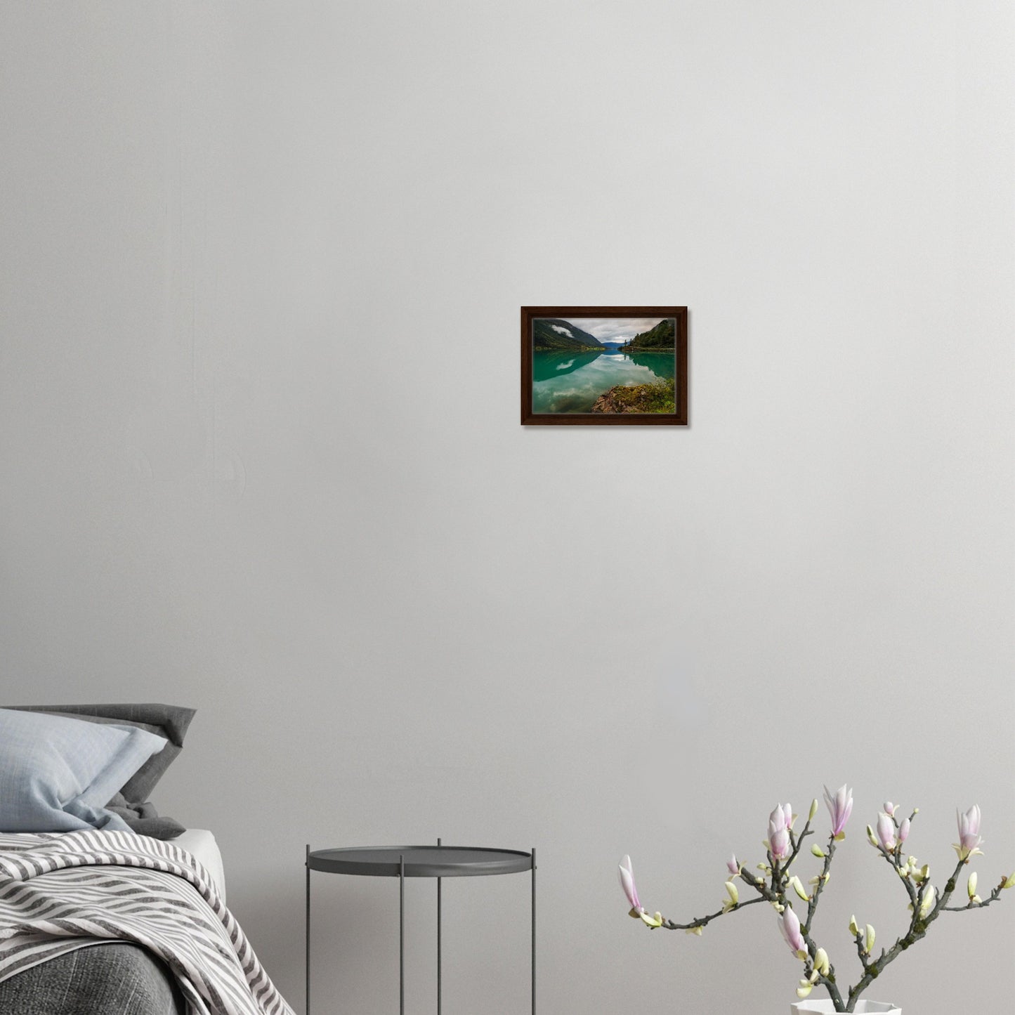 Framed canvas of calm lake with cloudy sky and green slopes