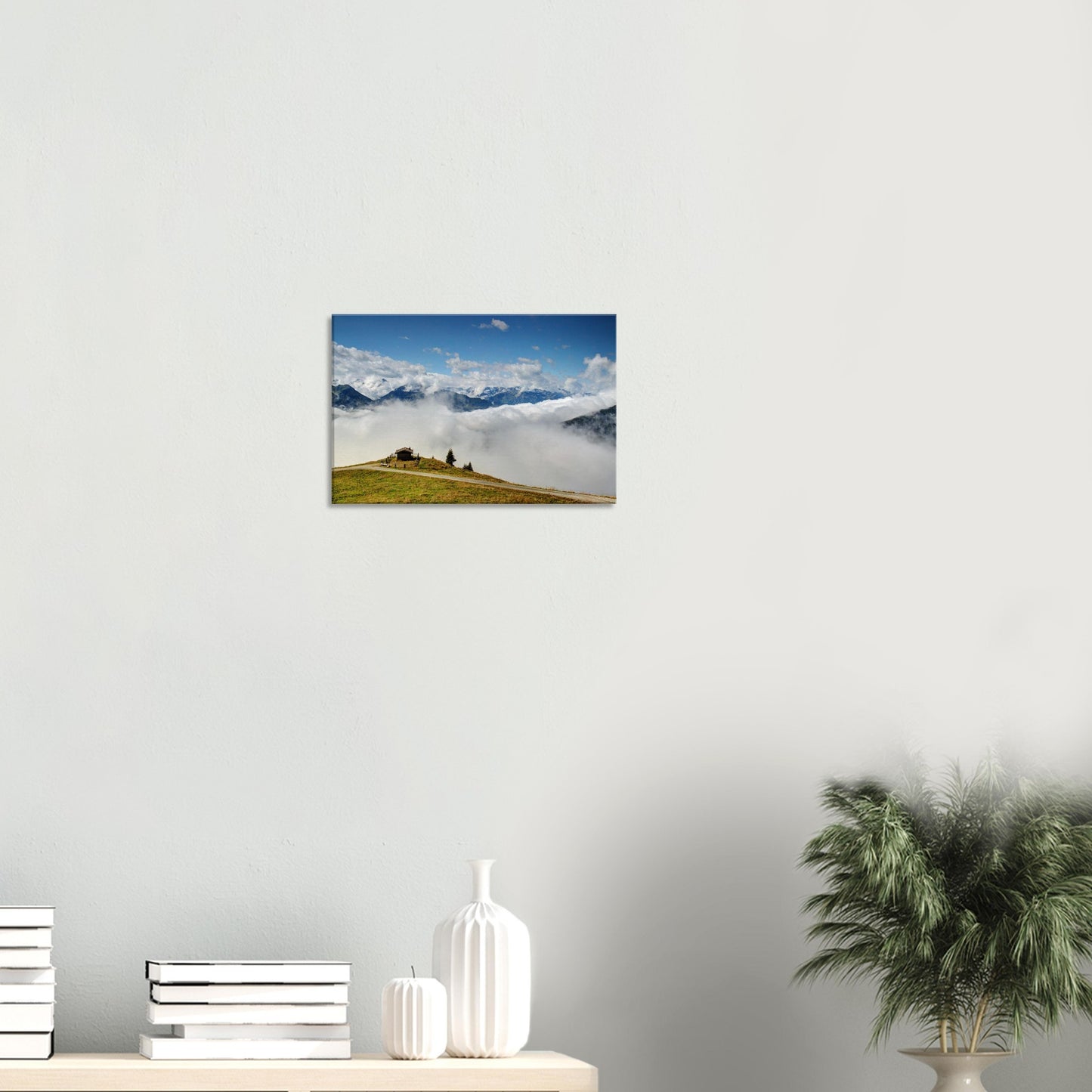 Peaceful alpine canvas print with a hilltop hut at Resterhöhe above clouds, surrounded by the rugged majesty of the Austrian Alps.