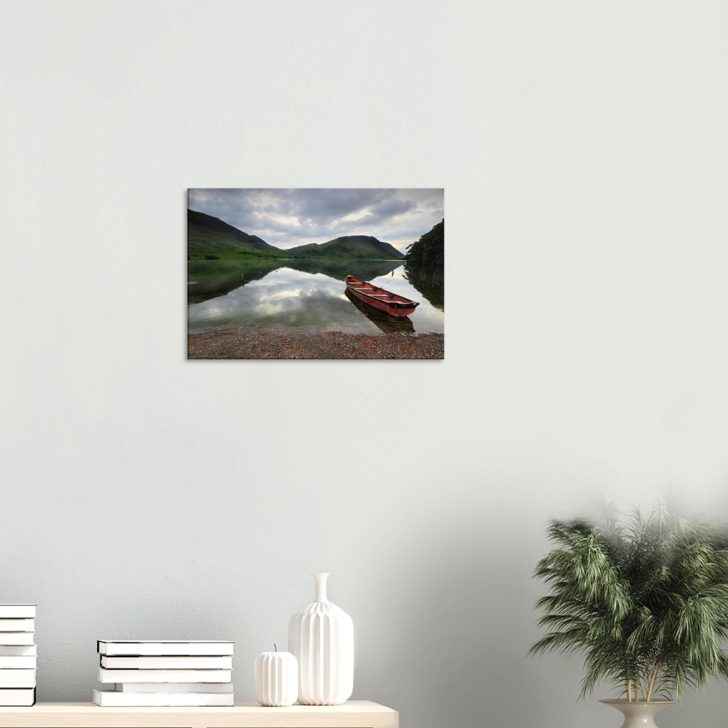Tranquil Lake District scene with red boat and calm waters