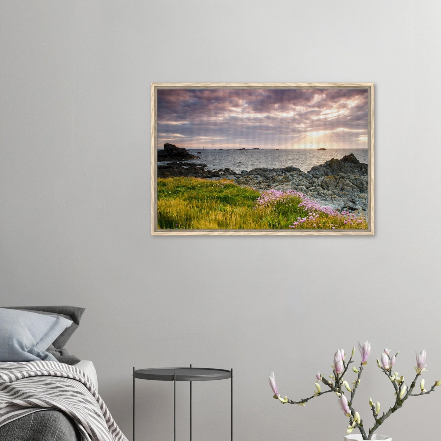 Framed landscape of sun setting over Pleinmont Point rocks and grass