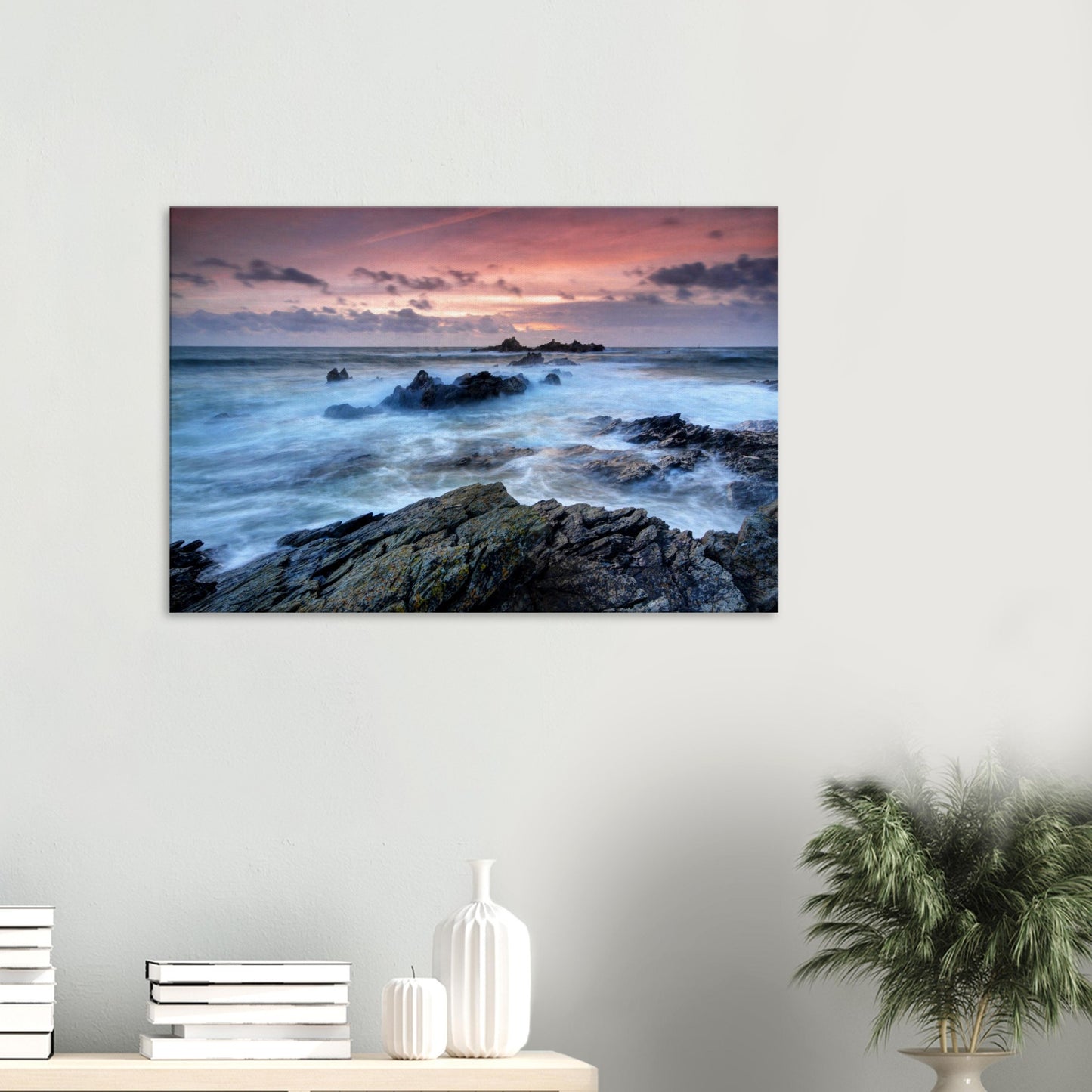 Canvas print of Heybrook Bay in Plymouth, Devon, showing swirling sea around jagged rocks under a fiery red and orange sunset sky.