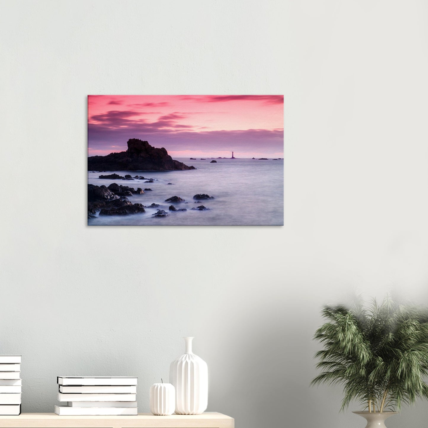 Canvas of Les Hanois Lighthouse standing tall under a pastel sunset, with coastal rocks bathed in fading light.