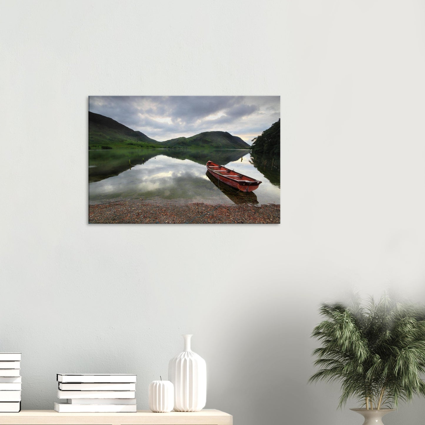 Calm Crummock Water landscape with quaint red boat