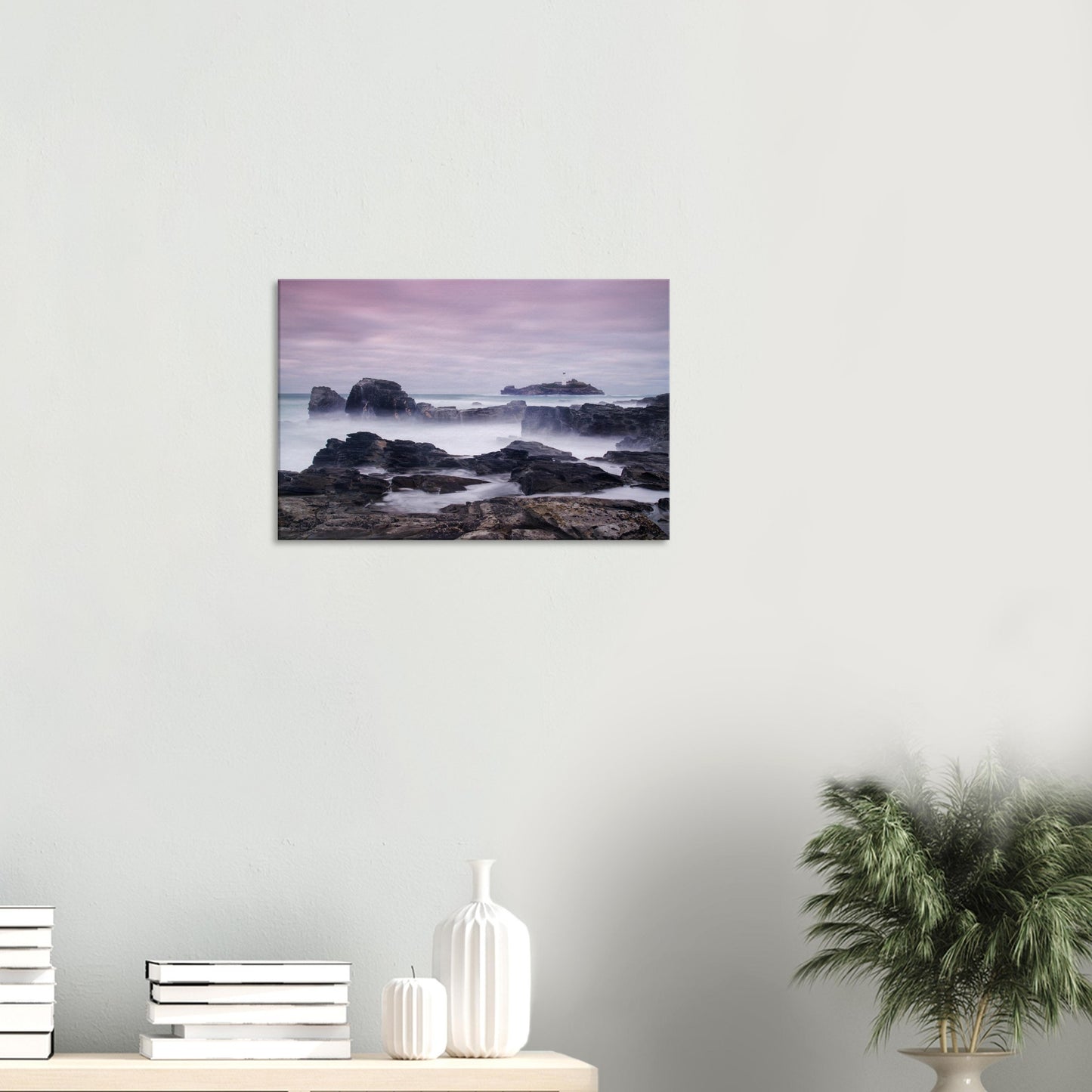 Atmospheric canvas of Godrevy Lighthouse surrounded by misty sea and rugged rocks, with soft hues of lavender and peach in the sky.