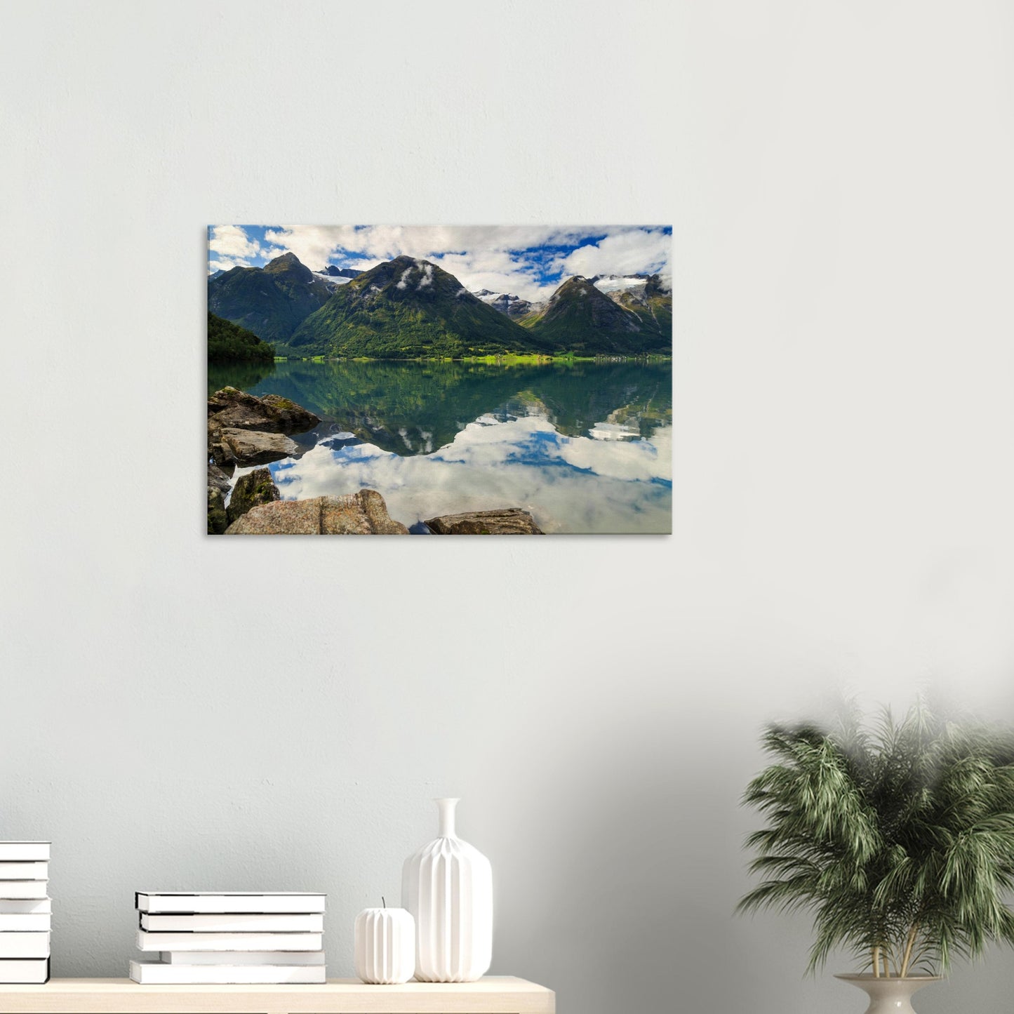 Tranquil landscape featuring dramatic mountain peaks rising above calm, reflective lake waters