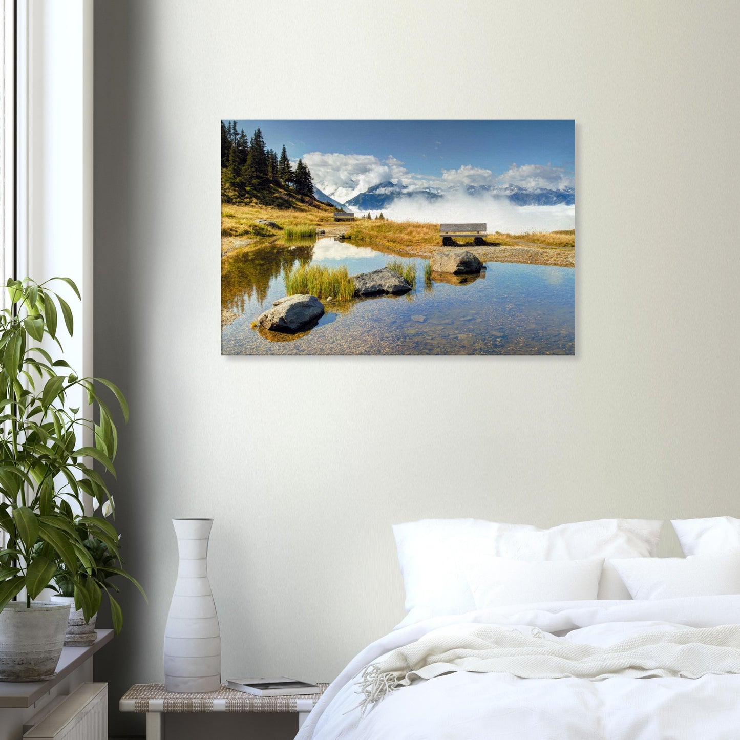 Canvas print of a tranquil mountain scene at Resterhöhe with a sky-reflecting pond, viewing bench, and cloud-wrapped alpine range.