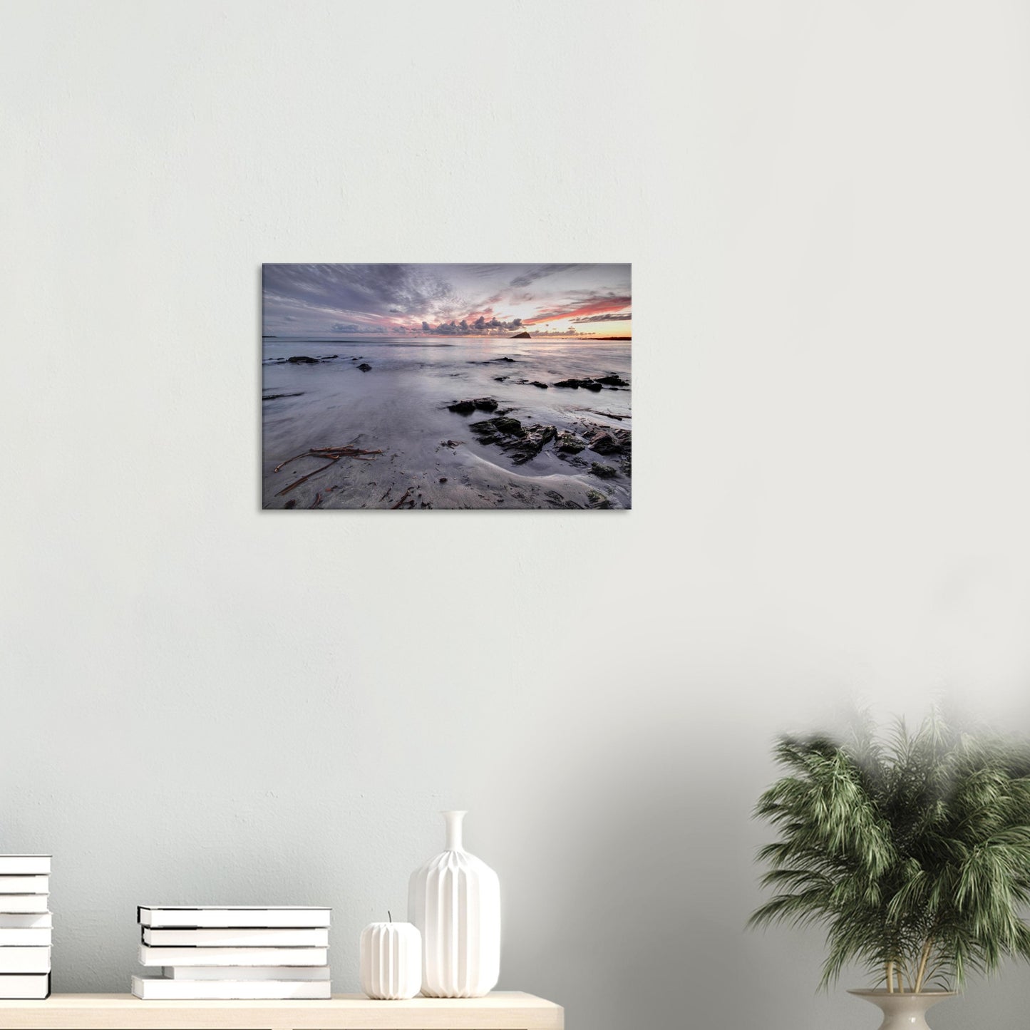 Canvas print of Wembury Beach’s serene sunset scene, with tide-washed sands, scattered rocks, and Mewstone silhouetted against soft pink skies.