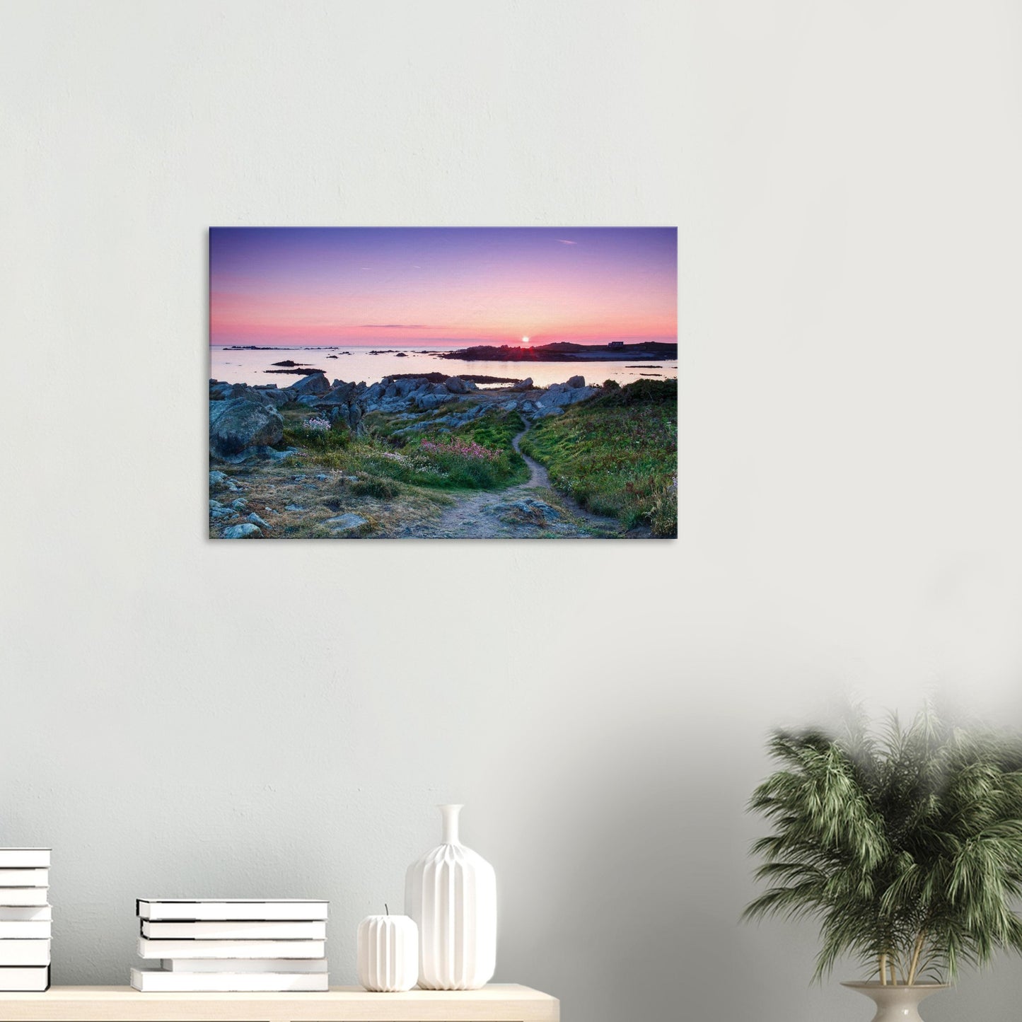 Sunset canvas of Lihou Island with reflective pools, a glowing horizon, and colourful wildflowers enhancing the foreground.