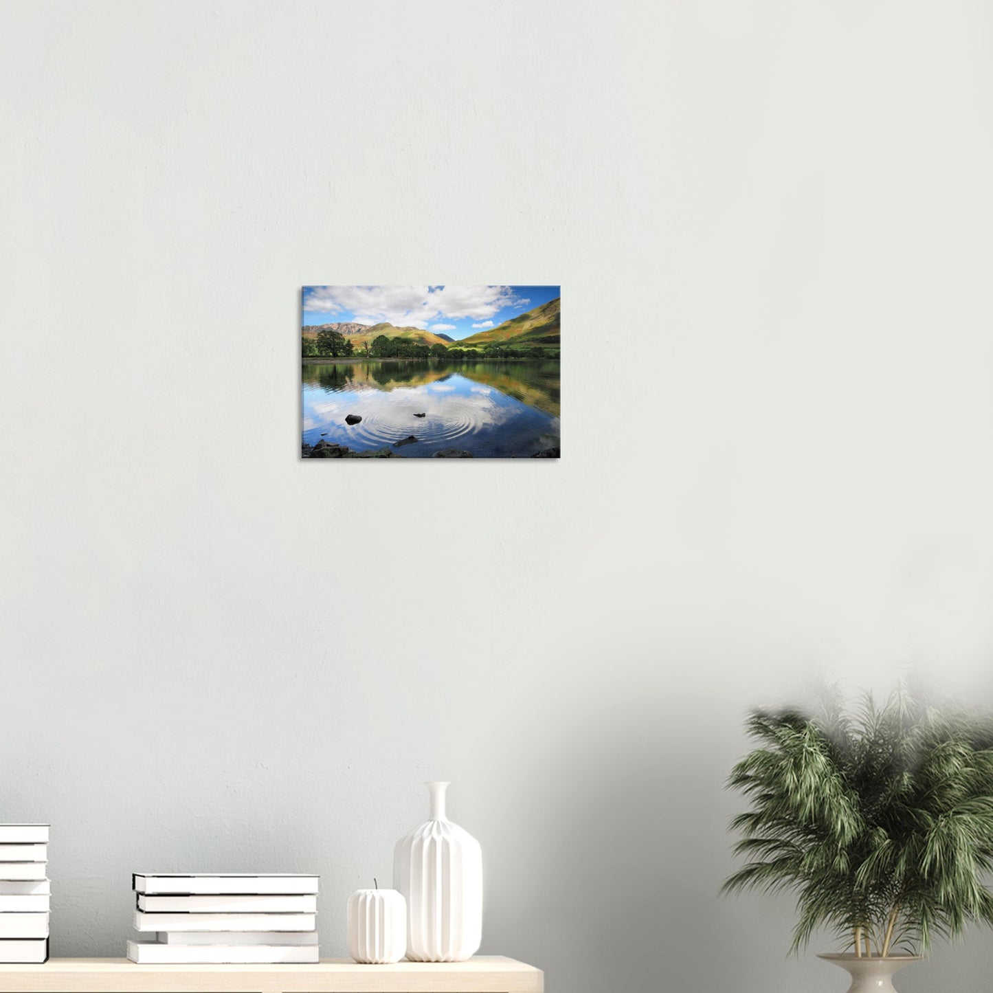 Buttermere Lake canvas showing gentle surface ripples and partial reflections of clouded sky and vibrant hills in soft, natural light.