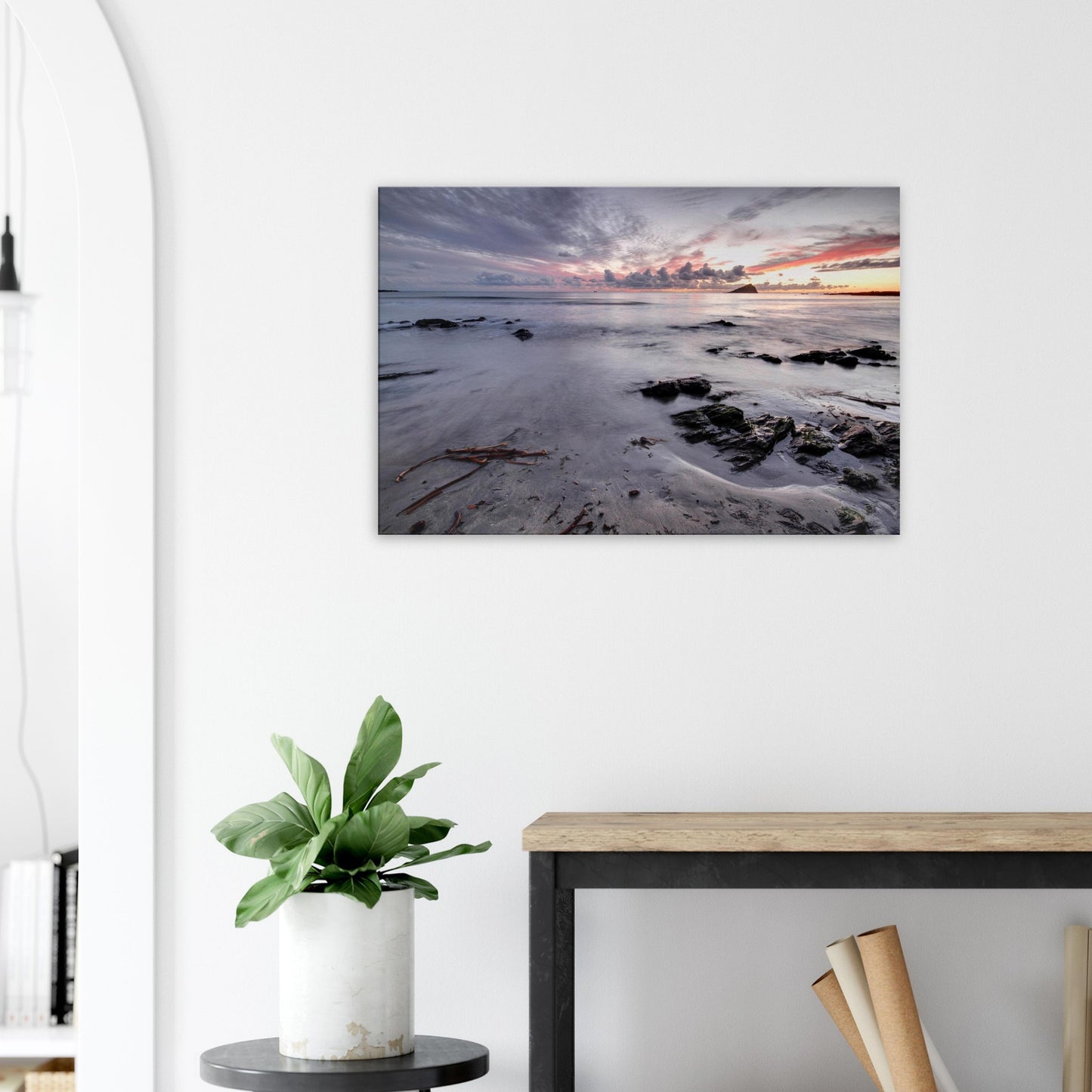 Canvas print featuring Wembury Beach with calm tide, sandy shore, scattered driftwood, and the silhouetted outline of Mewstone under dusky skies.