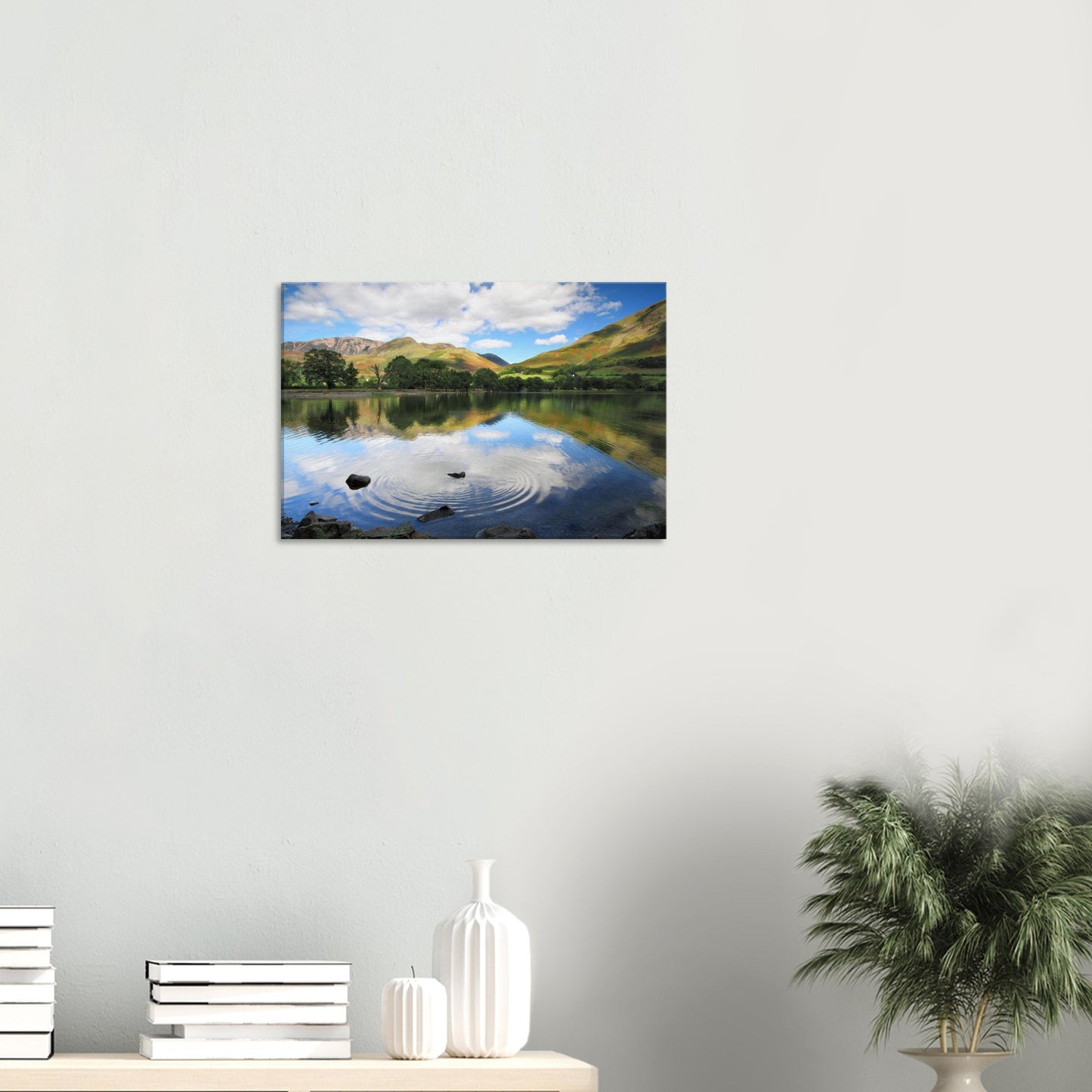 Canvas print capturing Buttermere Lake’s serene waters, with ripples expanding from a single stone across mirror-like reflections.
