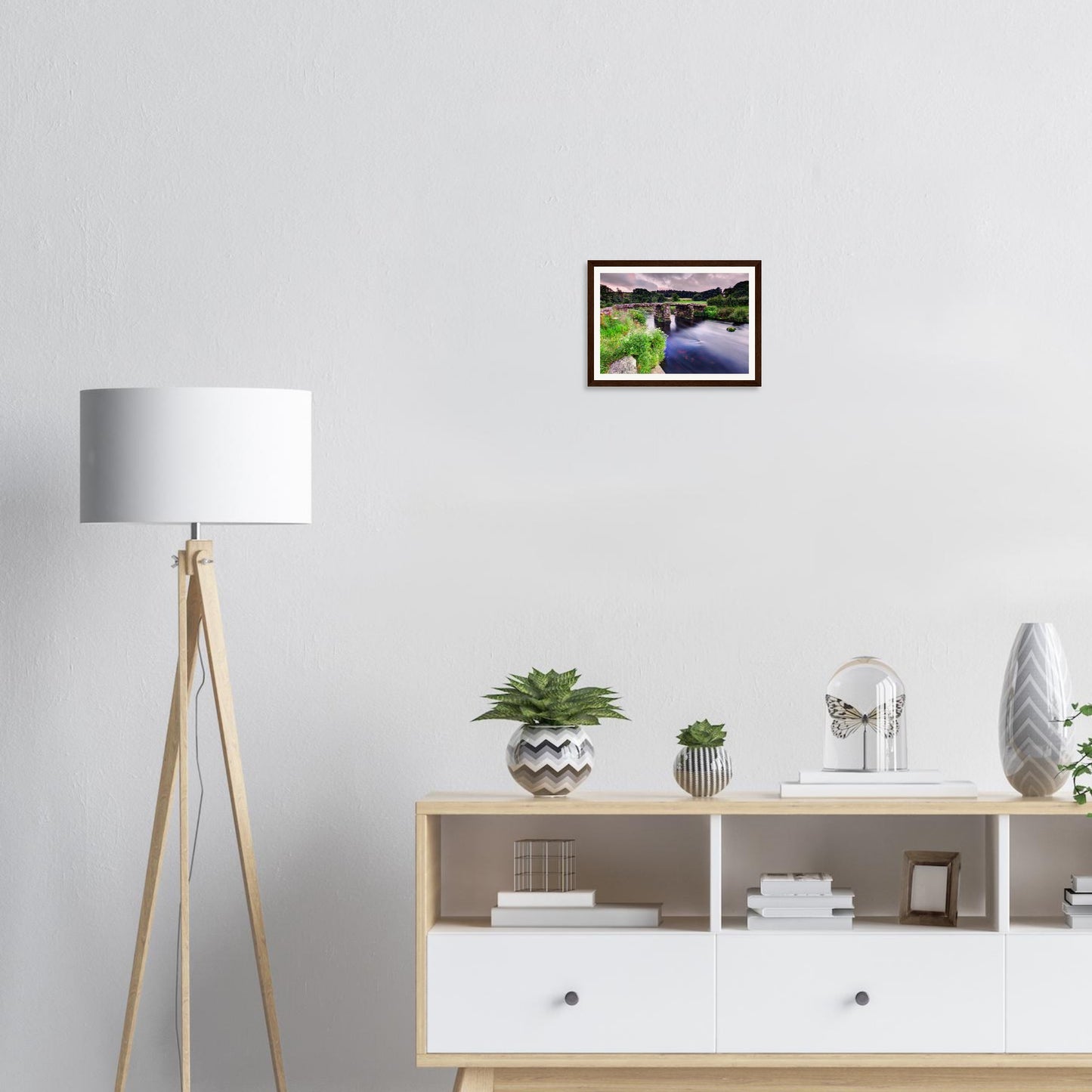 Stone clapper bridge surrounded by greenery in Dartmoor framed wall art