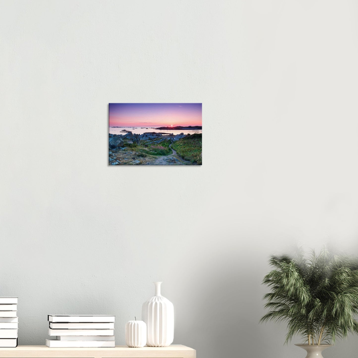 Coastal wall art of Lihou Island in Guernsey with a winding path, sunset glow, and the tide reflecting fiery evening light.