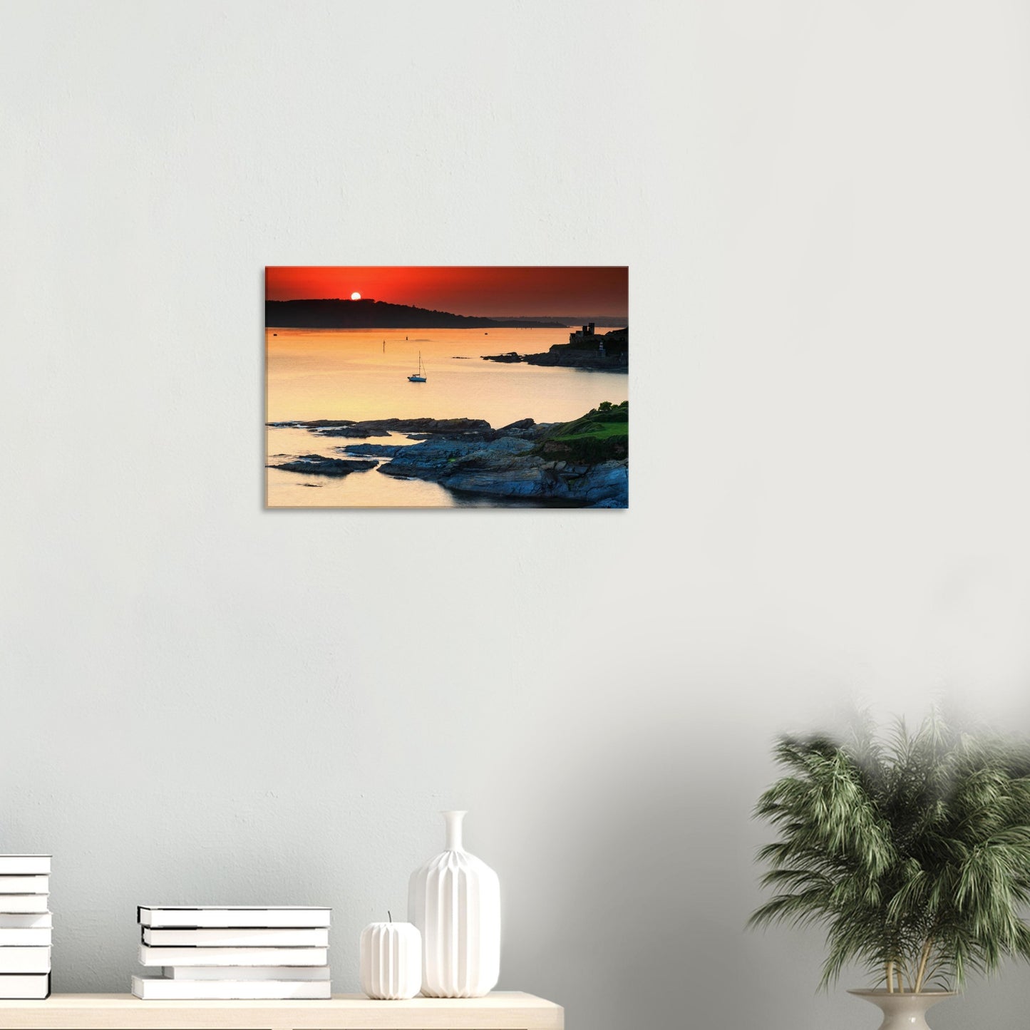 Plymouth Sound sunset artwork featuring glowing sky, calm sea, and a lone sailboat.