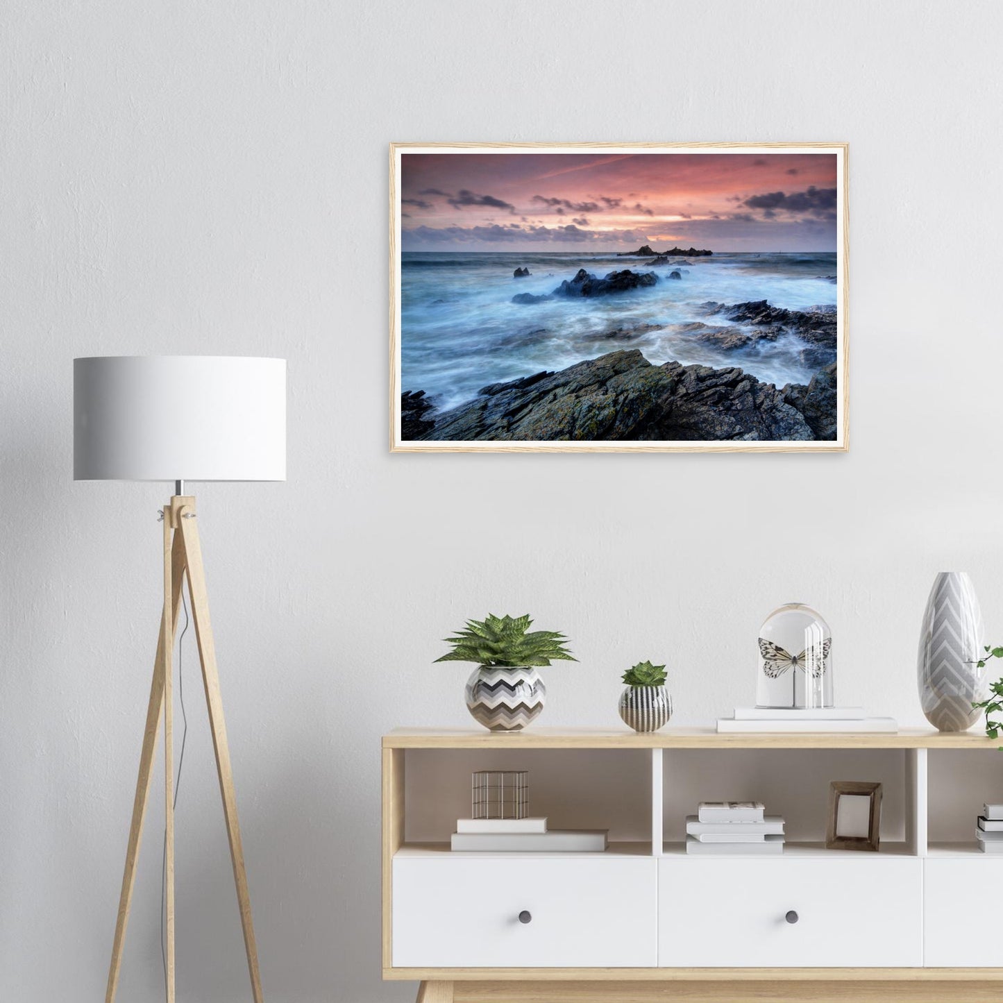 Waves crashing against rocks at Heybrook Bay sunset framed art