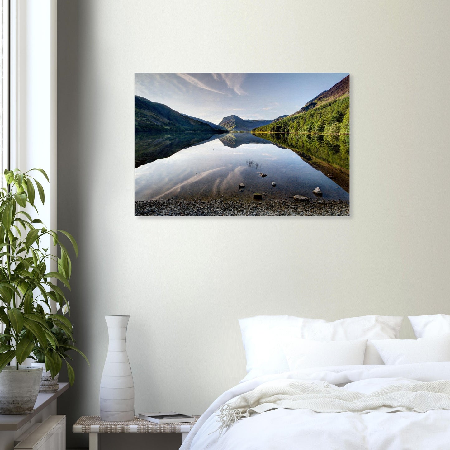 Canvas print capturing the reflective calm of Buttermere Lake with mirrored fells and a touch of morning sunlight on jagged peaks.