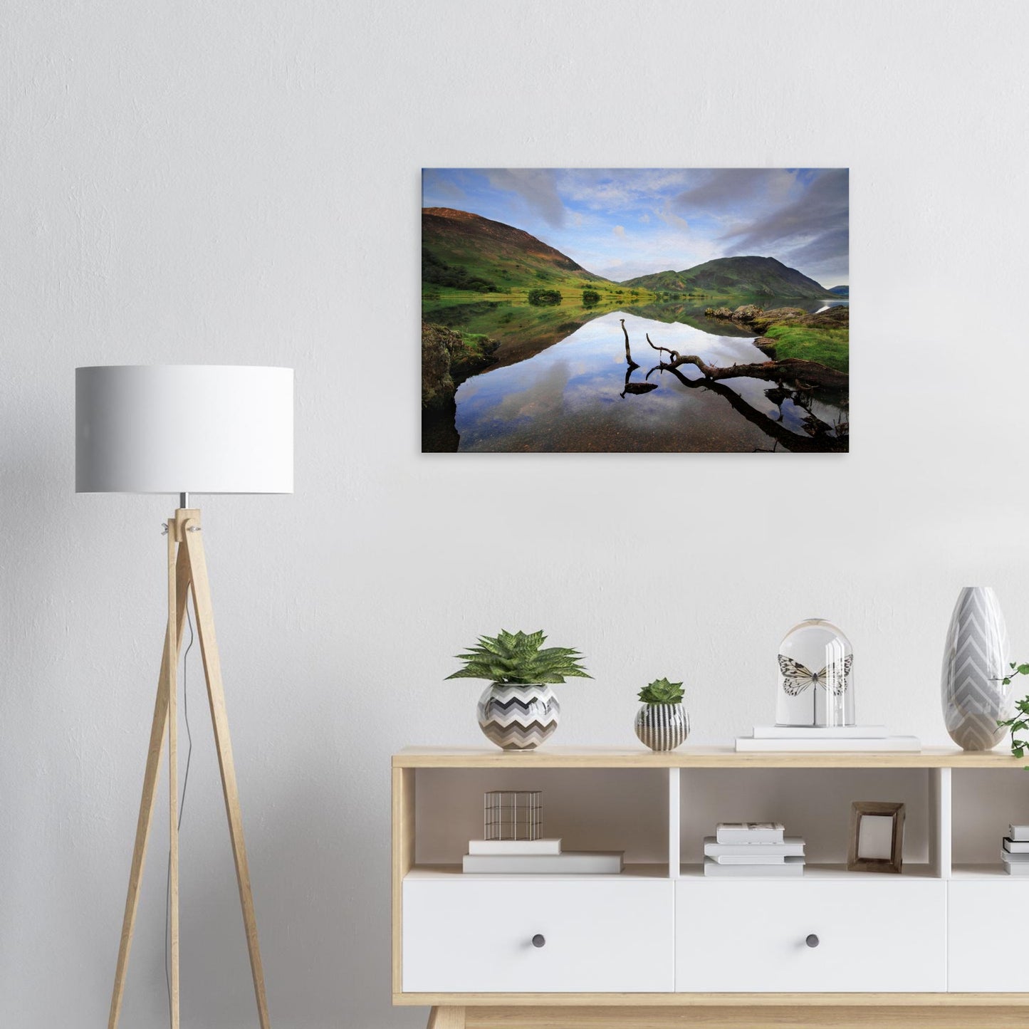 Canvas print capturing Crummock Water’s serene beauty with a solitary branch and still lake waters reflecting soft skies and surrounding hills.
