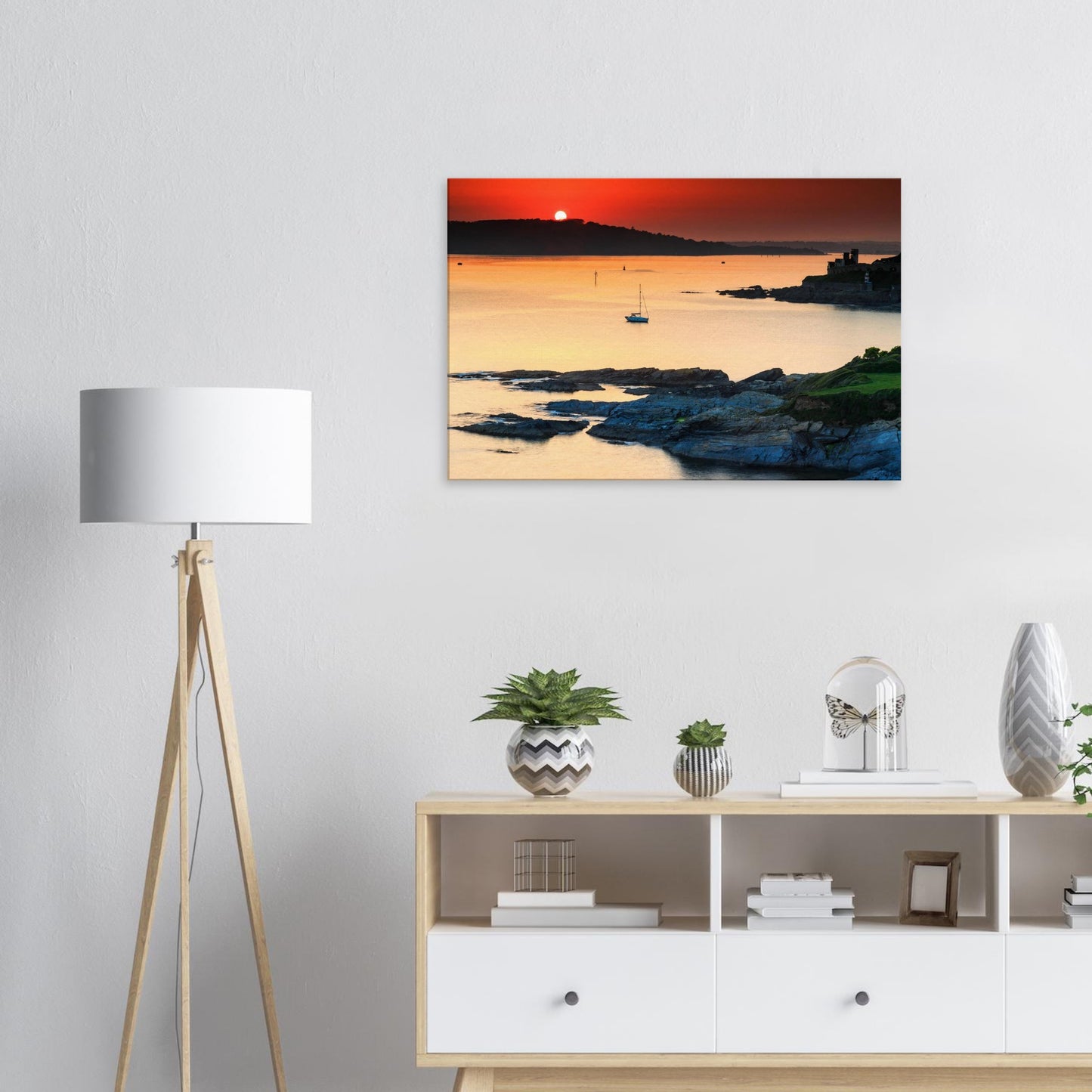 Historical Devon coast at golden hour, with sailboat and ancient fortifications on canvas.