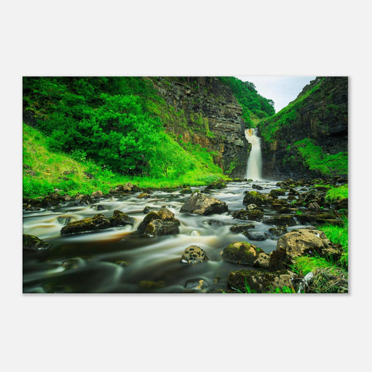 Dramatic Isle of Skye canvas print showing Lealt Falls cascade with misty spray and vivid plant life around the gorge.