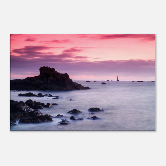 Dramatic coastal canvas of Guernsey at sunset, with Les Hanois Lighthouse and a sea washed in pinks and purples.