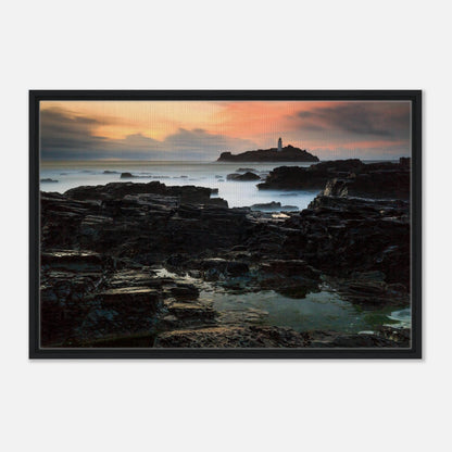 Sunset glow over Godrevy Lighthouse and rugged coastline in print