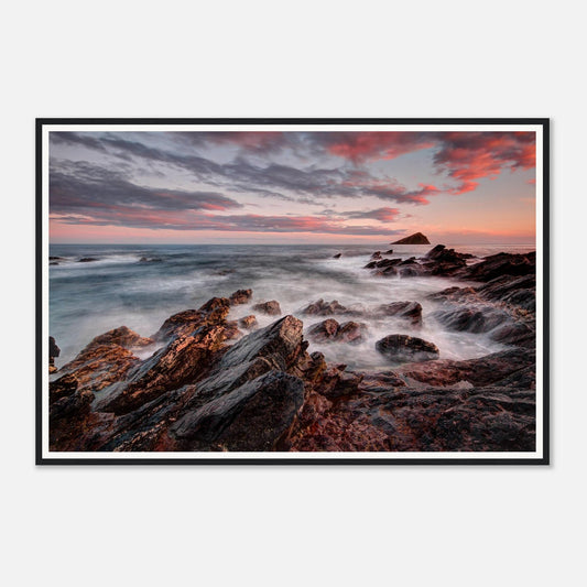 Evening light casting pink and orange sky over Wembury Beach