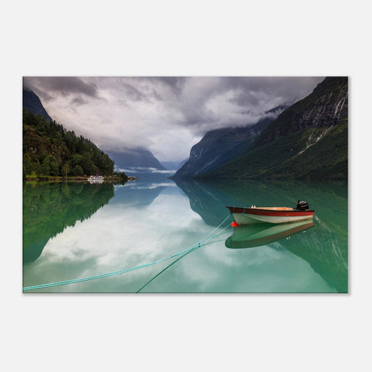Tranquil Norwegian lake scene featuring a tethered boat and misty mountain backdrop.