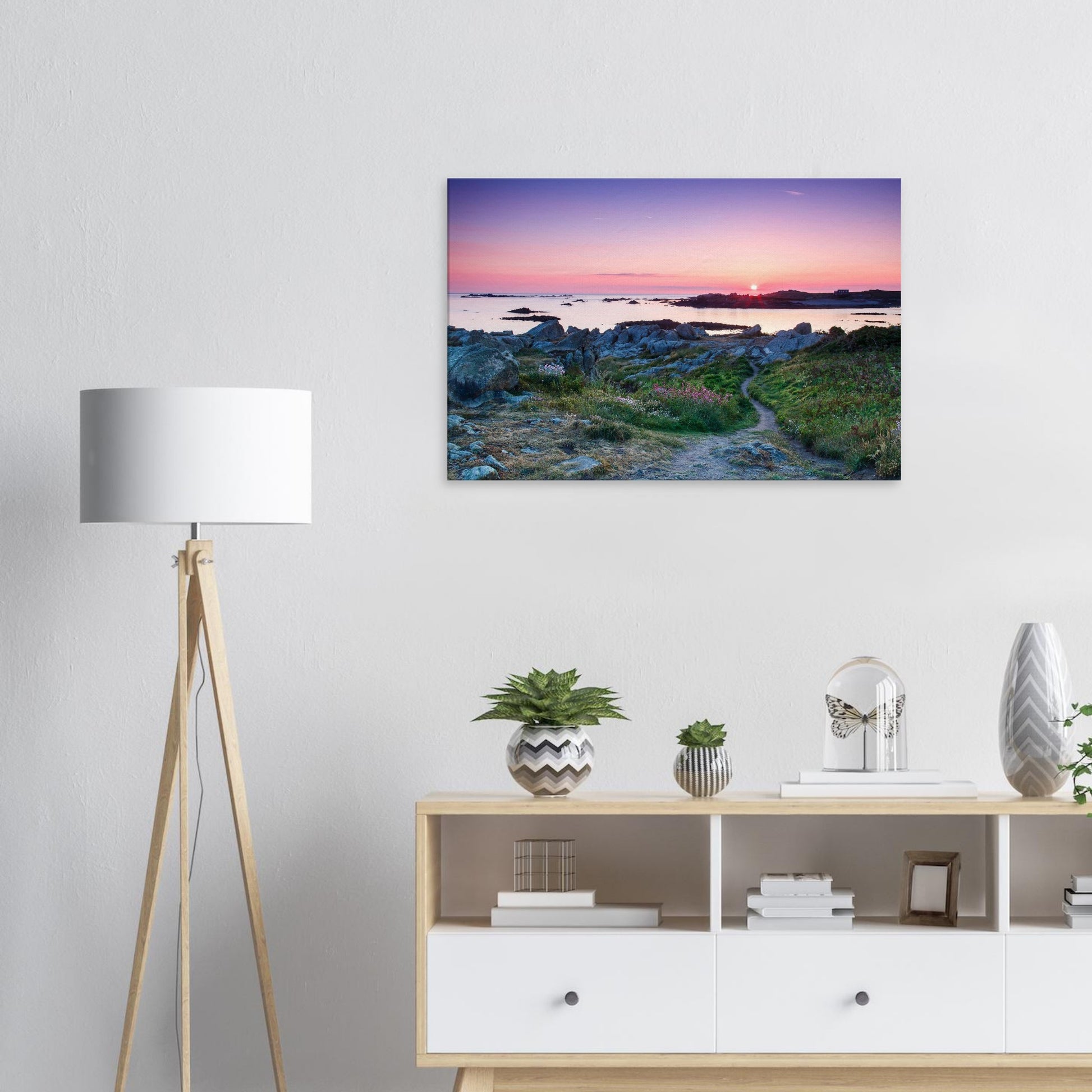 Peaceful sunset canvas of Lihou Island in Guernsey with soft light reflecting off tide pools and blooming wildflowers.