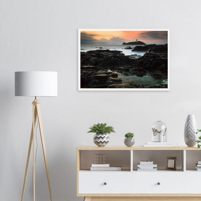 Evening glow across Godrevy Lighthouse rocks framed wall art
