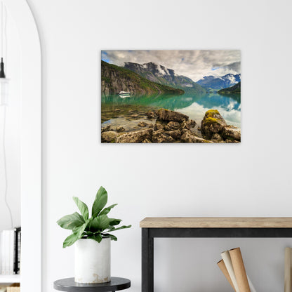 Canvas print capturing the contrast between mossy foreground rocks and smooth reflective lake