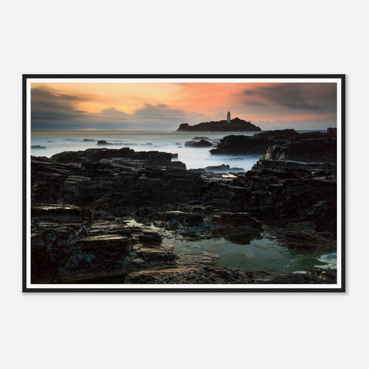 Sunset over Godrevy Lighthouse with glowing sky framed wall art
