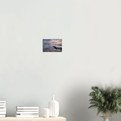 Sunset canvas of Wembury Beach in Devon featuring calm tide, smooth sands, driftwood, and Mewstone under a pastel-colored sky.