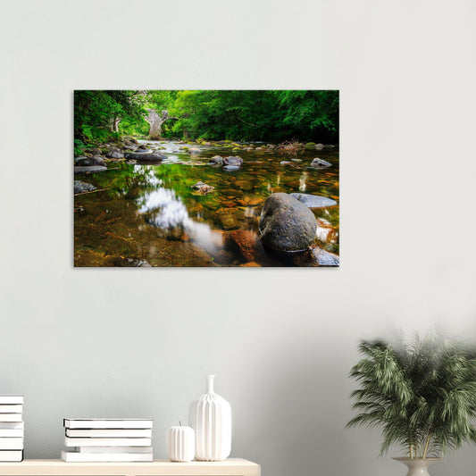 Canvas print of Newbridge on the River Dart with historic stone arches over flowing water