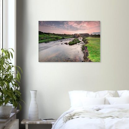 Sunlight breaking over Dartmoor hills and historic bridge scene