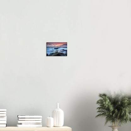 Canvas print illustrating the raw natural energy of Heybrook Bay with motion-filled waves and a vibrant fiery sunset sky.