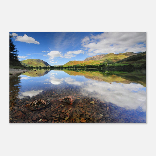 Buttermere landscape canvas artwork capturing transparent lake water, rich reflections, and the interplay of sunlight across lush fells and clouds.