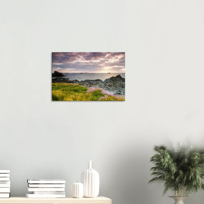 Landscape canvas of Pleinmont Point in Guernsey with illuminated wildflowers and Les Hanois Lighthouse beneath a vivid sunset sky.