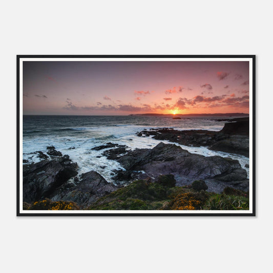 Golden evening light over Heybrook Bay rugged coastline